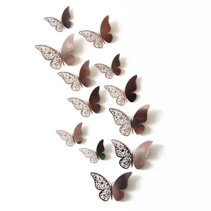 Detailed macro view of 3D rose gold butterfly wall stickers with intricate laser-cut hollow patterns