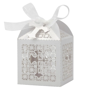 Detailed laser-cut white wedding favor box with cross pattern and elegant ribbon bow