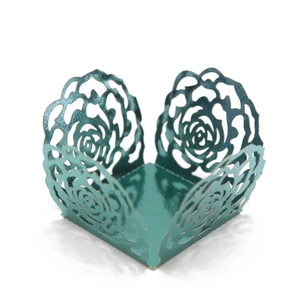 Detail of rose gold laser-cut cake border with intricate floral patterns for party decor