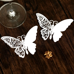 White laser-cut butterfly place cards for wine glass decoration at weddings and banquets