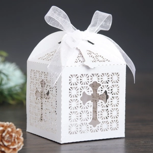 Laser-cut wedding candy box with a hollow cross design and white ribbon bow detail