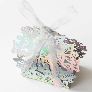 Close-up of holographic butterfly laser-cut gift box with a sheer silver organza ribbon bow