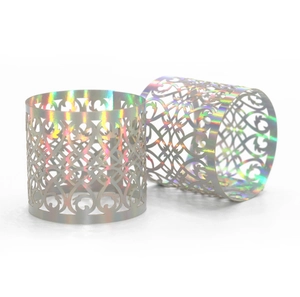 Detail of rose gold mirror paper napkin ring with laser-cut heart and vine patterns