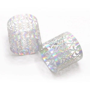 Detail of laser-cut hollow floral napkin rings with iridescent holographic coating
