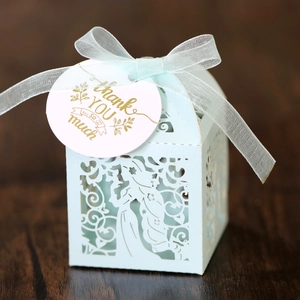 Detailed view of hollow light blue candy box with floral laser cut and Thank You tag