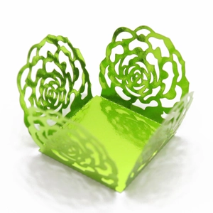 Macro view of green laser-cut floral rose patterns on metallic reflective cake lace wraps