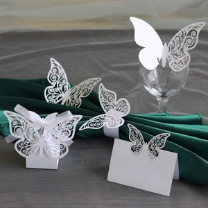 Detailed laser-cut white butterfly wedding decor set with gift box and napkin rings