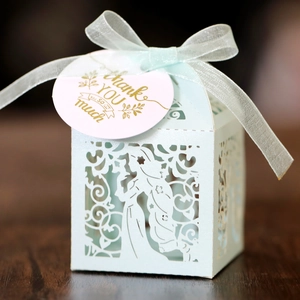 Detail of laser-cut light blue candy box with elegant silhouette and Thank You gift tag