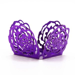 Detail of laser-cut purple paper cupcake wrappers with intricate floral patterns