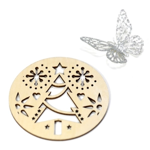 Detail of Christmas snowflake laser-cut wooden coaster with hollowed holiday patterns
