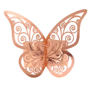 Detail of rose gold laser-cut butterfly napkin ring with intricate hollow patterns