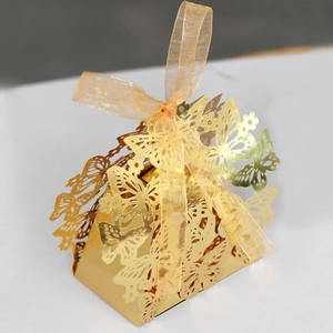 Detailed laser-cut hollow butterfly wedding candy box with golden organza ribbon bow