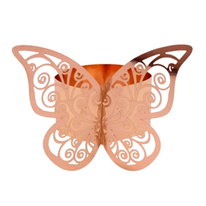 Close-up of laser-cut rose gold butterfly napkin ring with intricate scrollwork