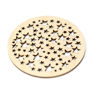 Detail of round wooden coaster with laser-cut star patterns on white background