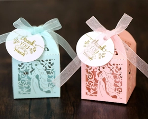Detailed laser-cut gift box featuring hollow girl and flower motifs with satin ribbons