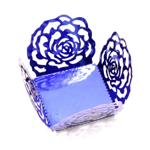 Detail showing royal blue laser-cut hollow rose pattern on decorative cupcake wrapper