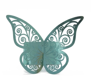 Macro shot of laser-cut butterfly napkin ring with intricate scroll patterns in cyan