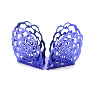 Detailed laser cut rose pattern on dark blue cupcake wrapper for party decor