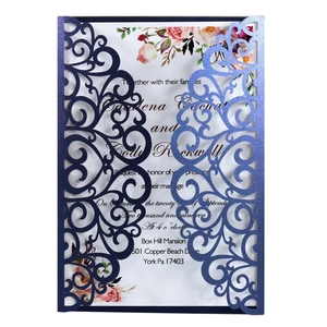 Macro detail of laser-cut navy wedding invitation sleeve with elegant floral card insert