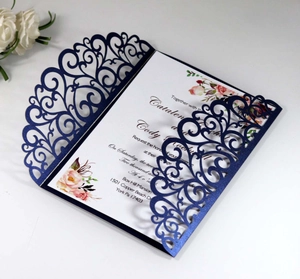 Detail of laser-cut navy wedding invitation sleeve with floral watercolor inner card