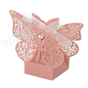 Detail of pink laser-cut butterfly gift box with rose patterns and white ribbon