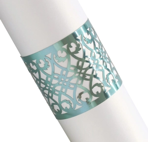 Close-up of laser-cut teal metallic napkin ring with ornate European hollow patterns