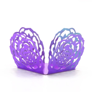 Detail of laser-cut violet cupcake wrapper featuring intricate rose floral patterns