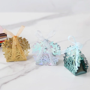 Detailed laser cut butterfly candy boxes with organza ribbons for wedding favors