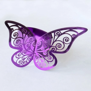 Detail of purple laser-cut butterfly napkin ring with intricate floral openwork pattern