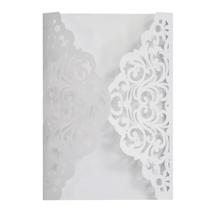 Elegant laser-cut wedding invitation cover with intricate floral patterns in white paper