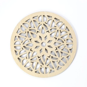 Macro detail of laser-cut wooden mandala coaster with intricate floral hollow design