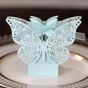 Detailed laser-cut light blue wedding favors box with rose patterns and a silk ribbon bow