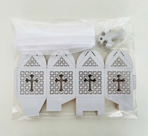 Detail of laser-cut wedding favor box kit with white ribbon and silver cross charm