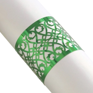 Macro shot of green laser-cut filigree napkin ring with a metallic mirror finish