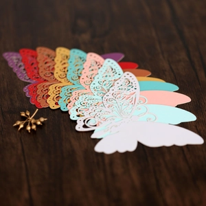 Macro detail of laser-cut butterfly cards with intricate hollow wings in vibrant colors