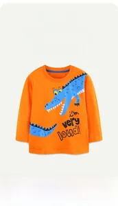 Detail of orange long sleeve kids shirt featuring a cartoon crocodile print and blue collar