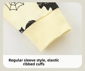 Close-up of elastic ribbed cuffs on a yellow Halloween sweatshirt with spider web prints