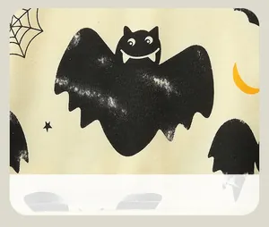 Macro shot of Halloween sweatshirt fabric with cartoon bats and spider web patterns