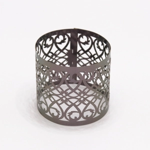 Detailed laser-cut scrollwork and heart patterns on rose gold metallic napkin ring
