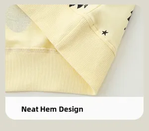 Detail of ribbed hem on kids' cream sweatshirt with black star print and neat stitching