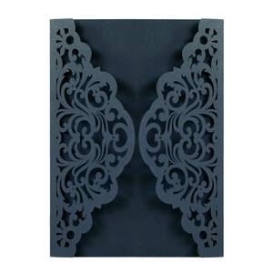 Detailed laser-cut European floral patterns on a dark blue wedding invitation cover