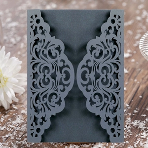 Close-up of elegant laser-cut floral invitation cover in charcoal grey paper cardstock