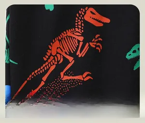 Détail de l'imprimé squelette de dinosaure coloré sur tricot noir pour pantalon enfant