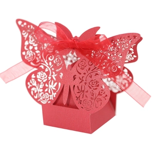 Detail of red butterfly gift box featuring laser-cut rose patterns and organza ribbon