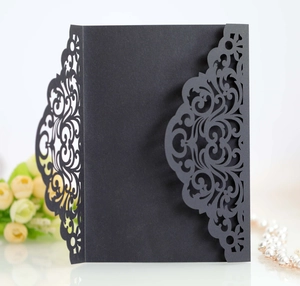 Detail of laser-cut rose patterns on black matte wedding invitation card case