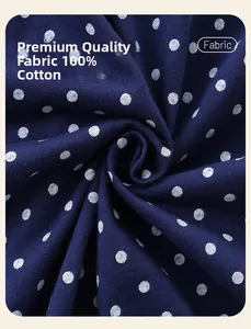 Detailed view of 100% cotton dark blue fabric with white polka dots and soft texture