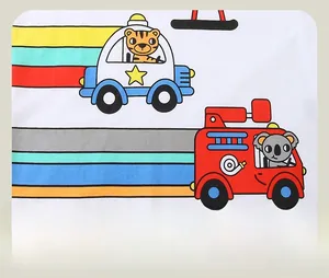 Detail of soft cotton fabric with cartoon tiger police car and koala fire truck prints