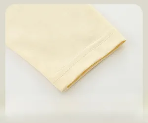 Detailed macro view of the soft knitted cuff with neat double-needle stitching on the sleeve