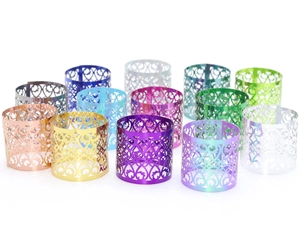 Macro detail of metallic hollowed vine pattern napkin rings in assorted vibrant colors