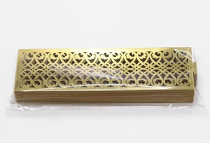 Close-up of laser-cut rose gold napkin rings with intricate floral vine patterns